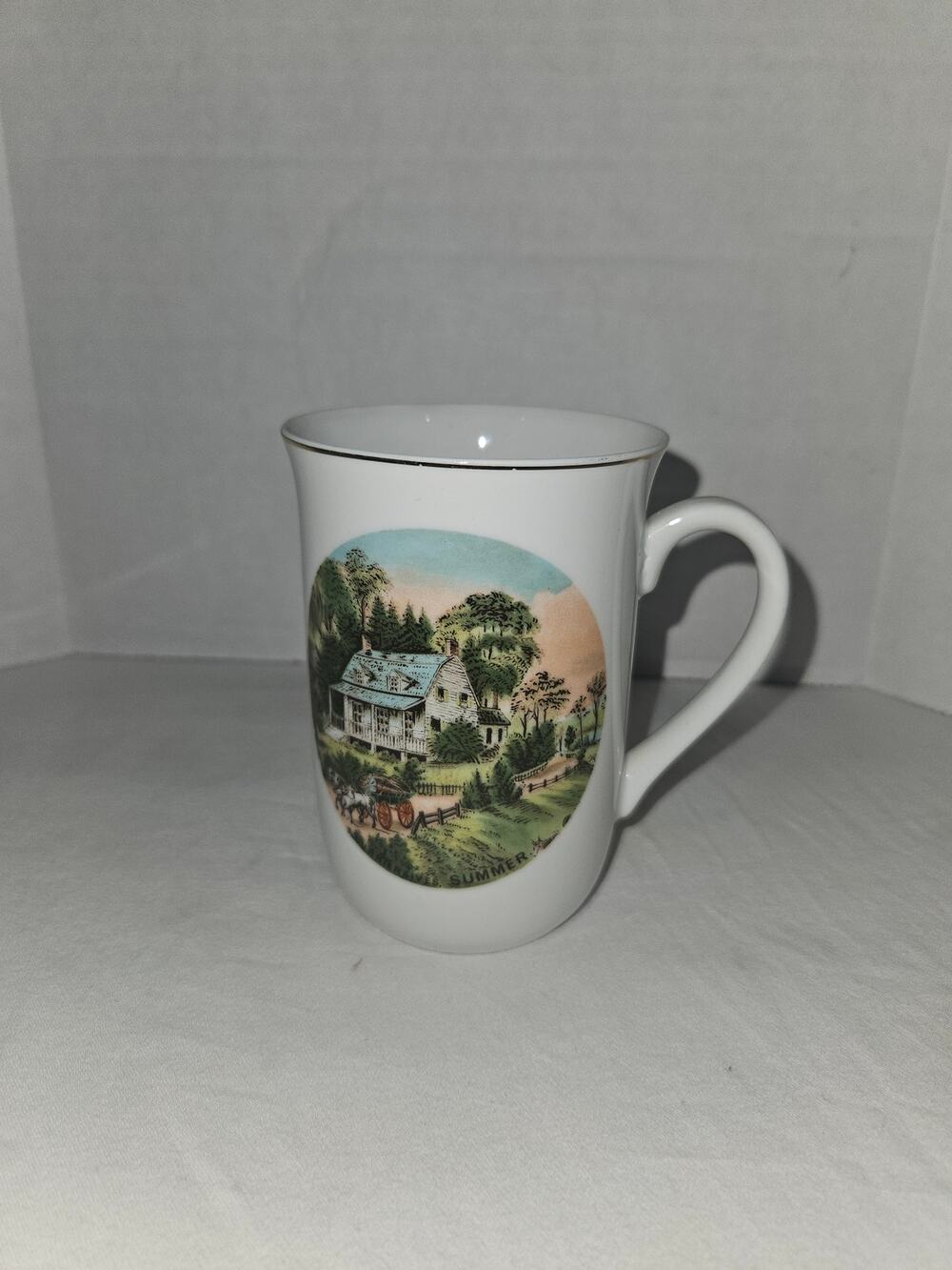10 oz white porcelain Currier and Ives Summer scene mug.